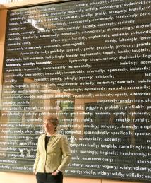 Carolyn Bertozzi standing in front of display at Stanford University