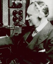 Guglielmo Marconi working with a radio